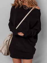 Model wearing black asymmetric batwing sweater dress with shoulder bag