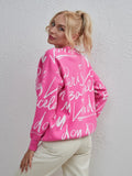 Woman wearing pink Letter Pattern Sweater with drawstring hem and dropped shoulder for stylish comfort.