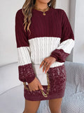 Woman wearing a color block cable knit sweater dress with a textured pattern in maroon, white, and burgundy.