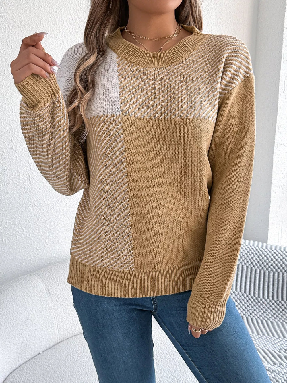 Woman wearing a Color Block Striped Sweater with round neck design, showcasing cozy textile and casual fashion style.