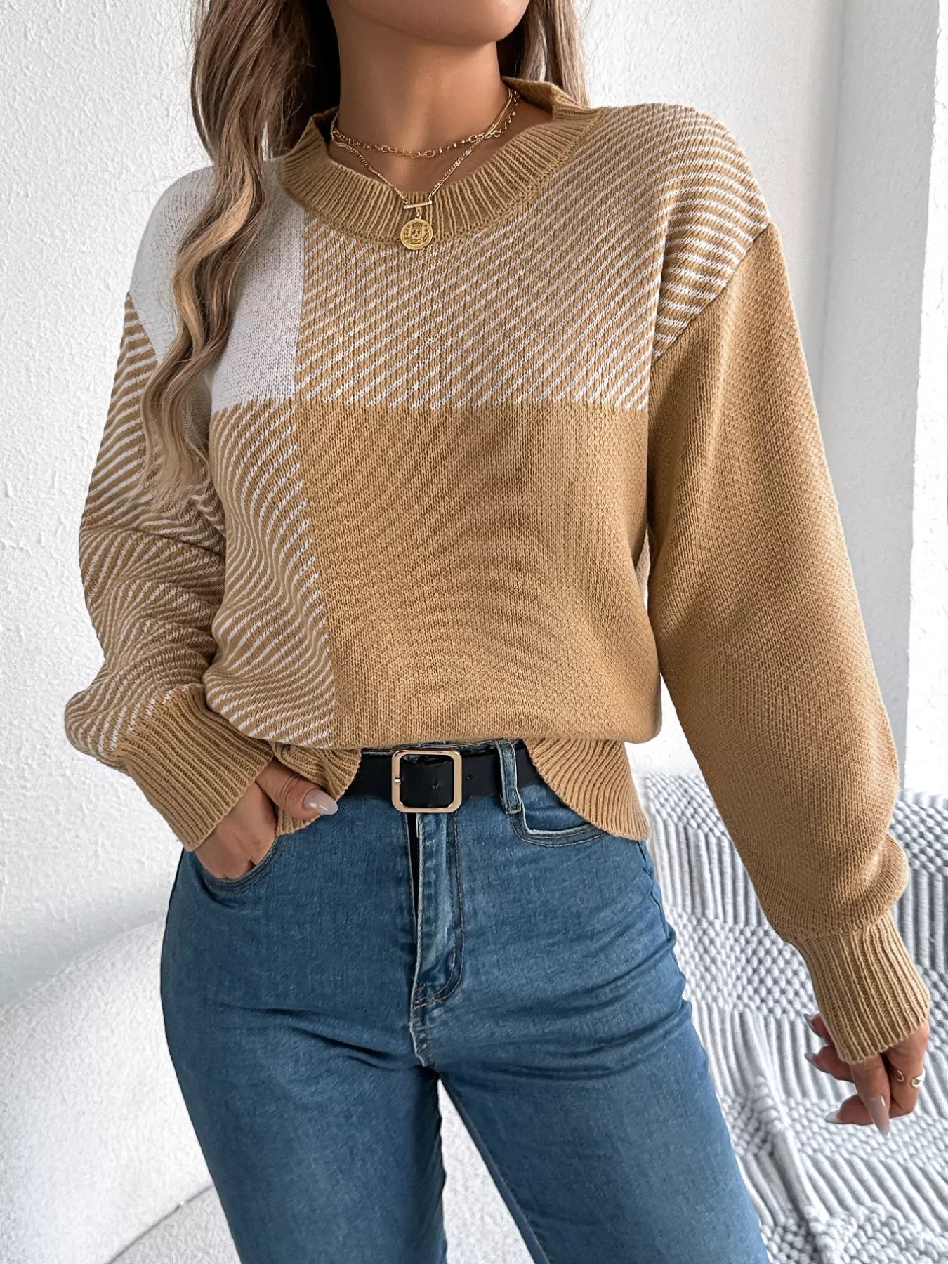 Alt Tag: Woman wearing Color Block Striped Sweater with round neck and bold striped pattern, paired with jeans for a cozy casual look.