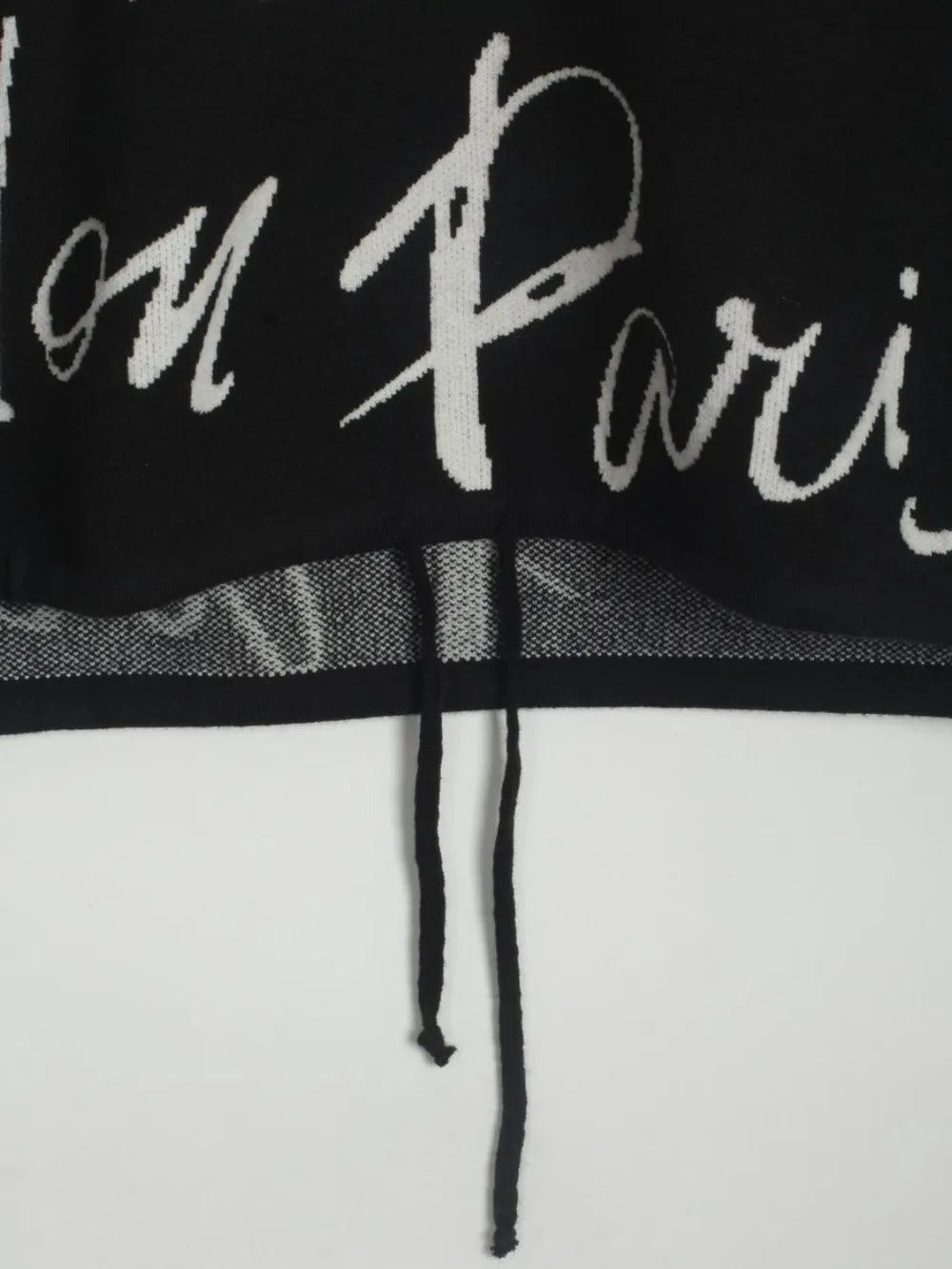 Close-up of Letter Pattern Sweater featuring drawstring hem and stylish design.