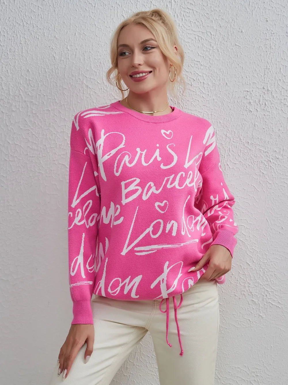Woman wearing pink Letter Pattern Sweater with drawstring hem and dropped shoulders