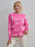 Woman wearing pink Letter Pattern Sweater with drawstring hem and dropped shoulders