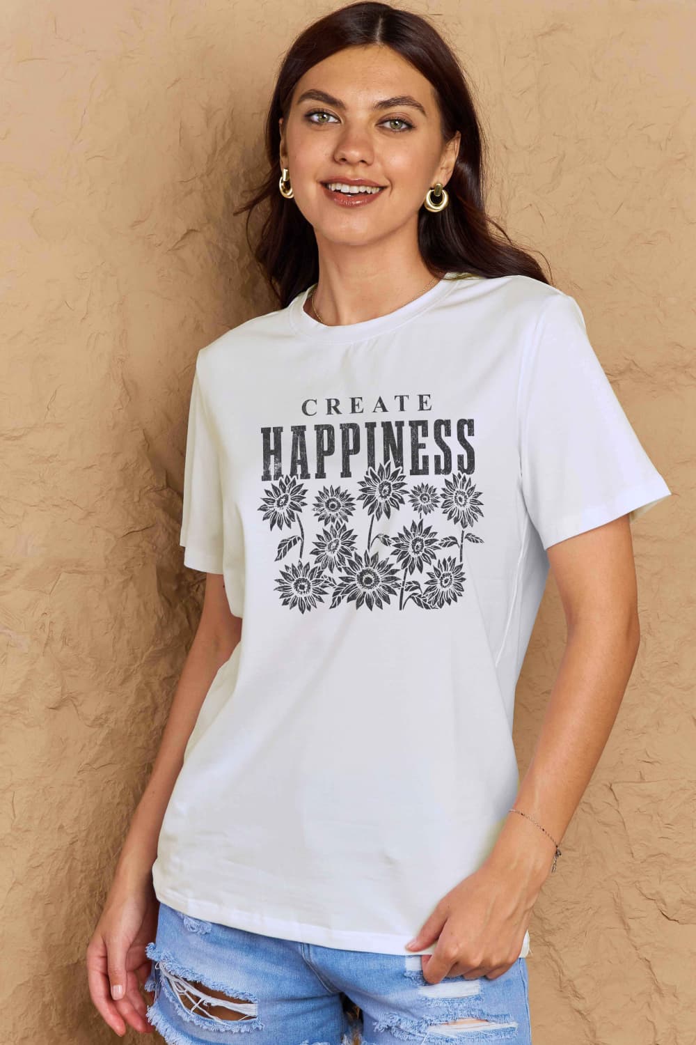 Woman wearing Graphic Cotton T-Shirt with 'CREATE HAPPINESS' print, casual style for uplifting and positive everyday wear.