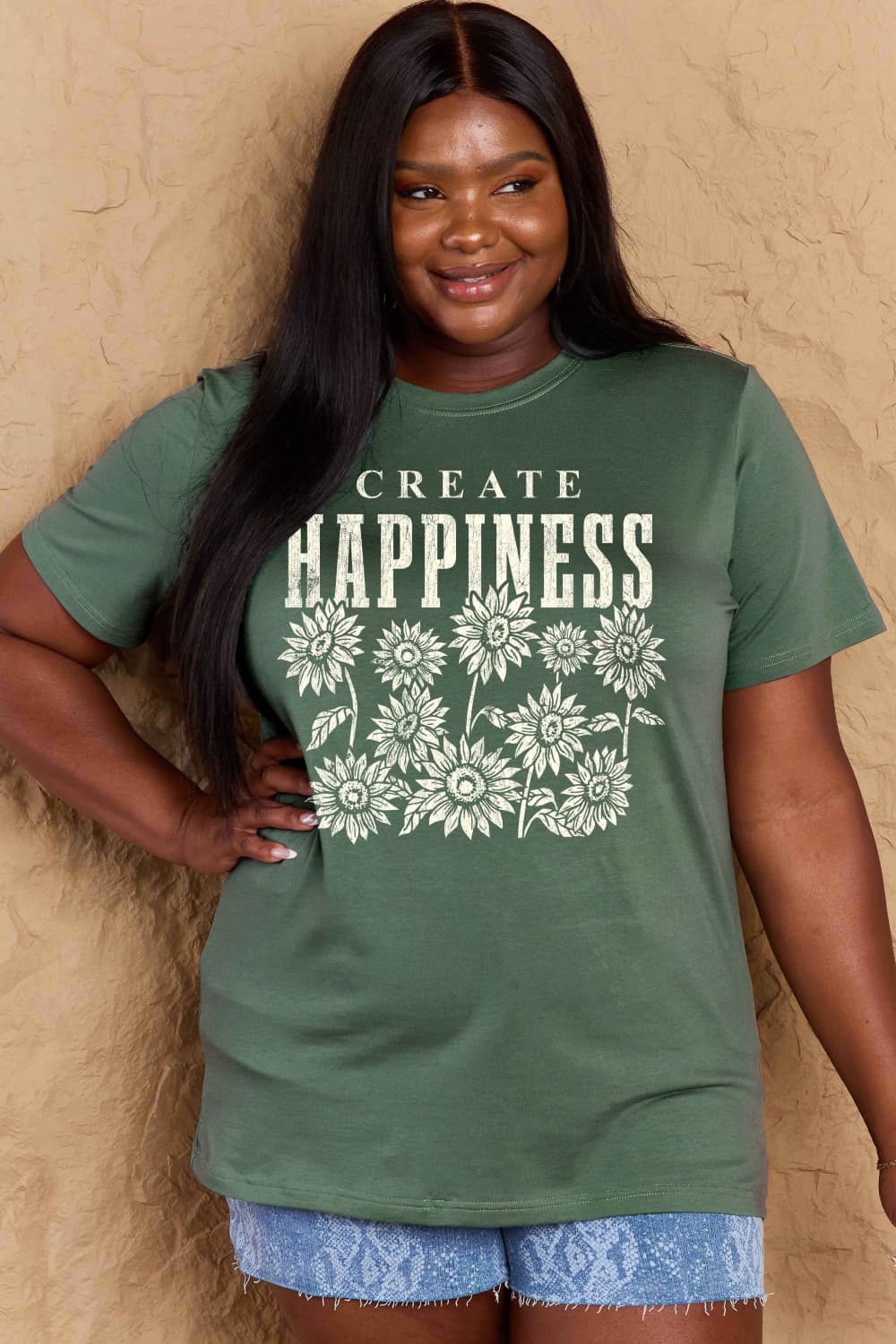 Woman wearing Graphic Cotton T-Shirt with 'CREATE HAPPINESS' slogan, showcasing comfortable casual style in full size for women.