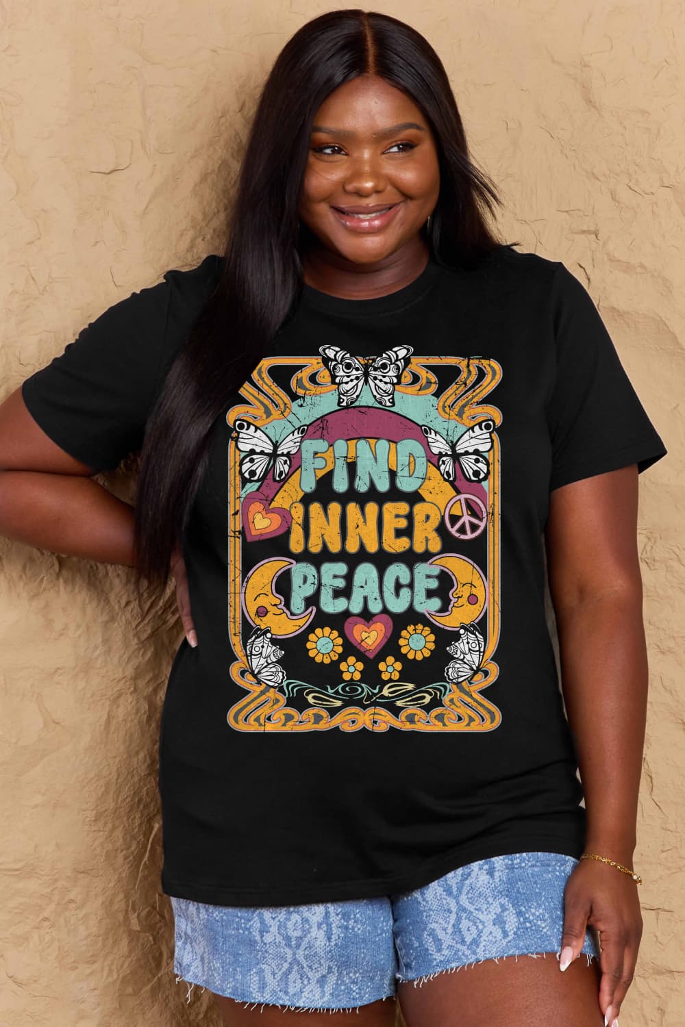 Woman wearing Graphic Cotton T-Shirt with 'FIND INNER PEACE' print, casual style, short sleeves, inclusive sizing.