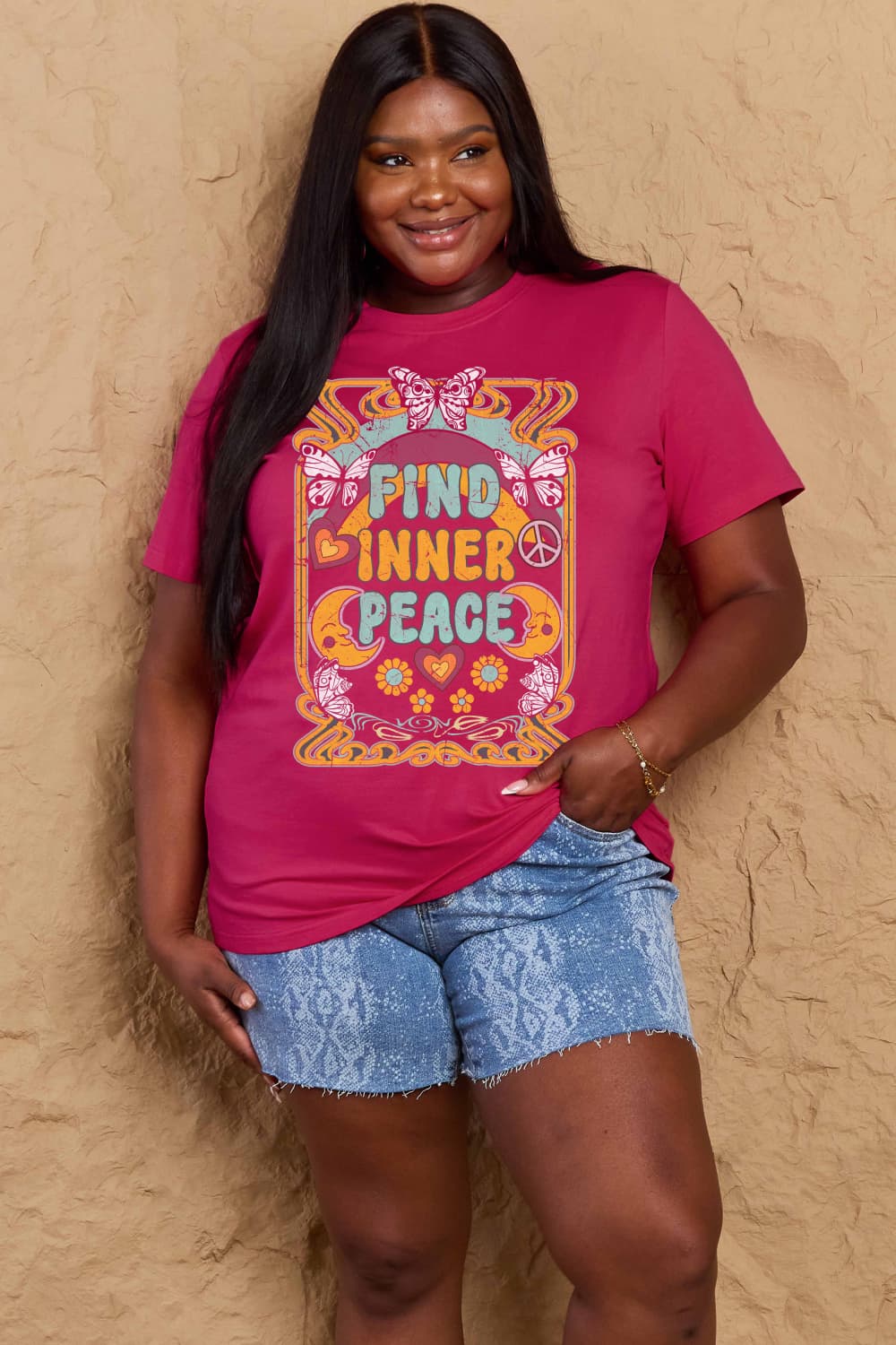 Woman wearing Graphic Cotton T-Shirt with 'FIND INNER PEACE' print in a casual setting.