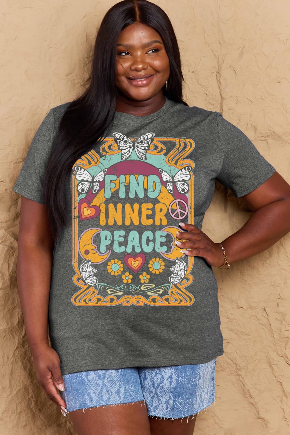 Woman wearing Graphic Cotton T-Shirt with “FIND INNER PEACE” design, casual fashion.