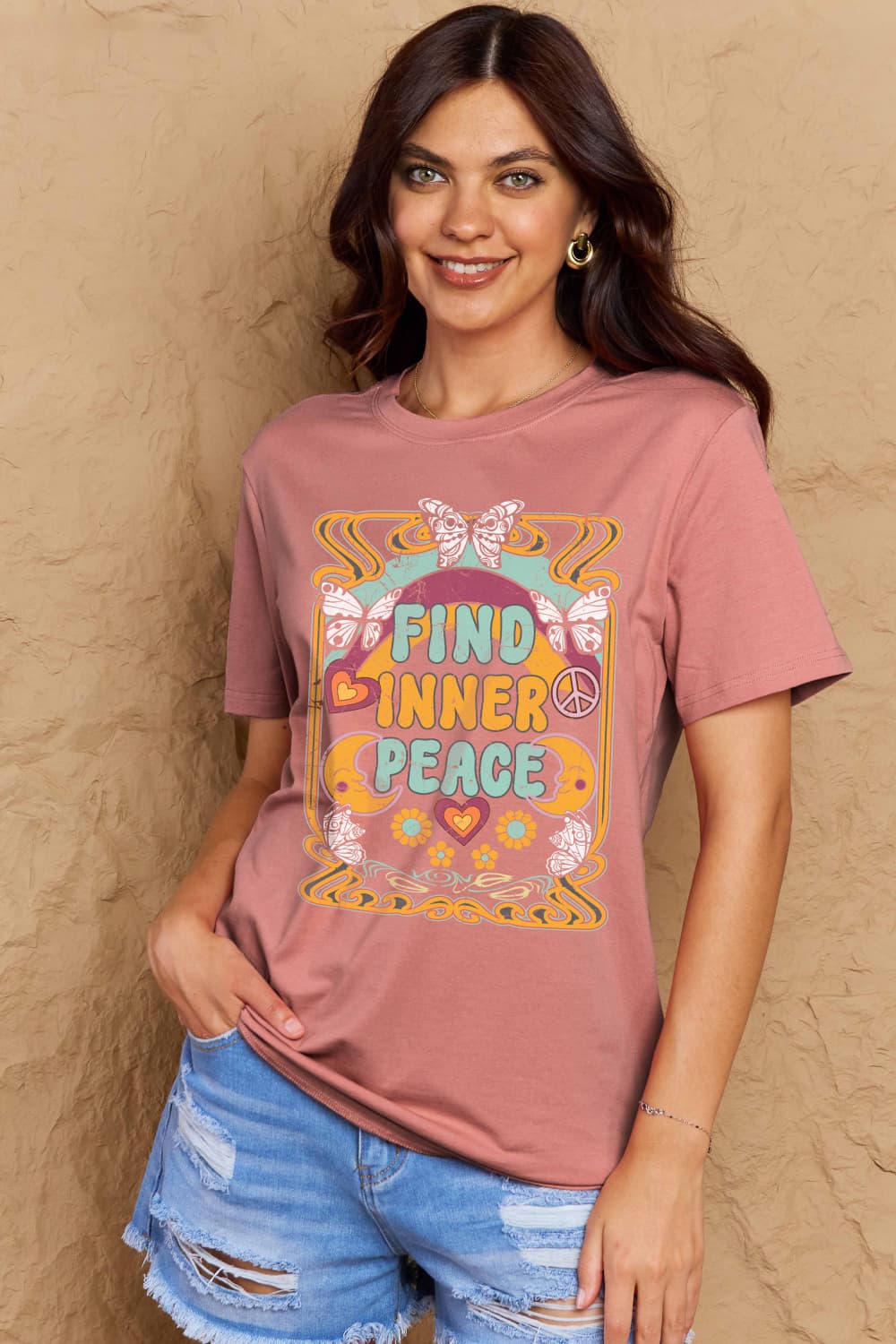Graphic Cotton T-Shirt with FIND INNER PEACE print, featuring a woman in a pink tee and denim shorts, perfect for casual wear.