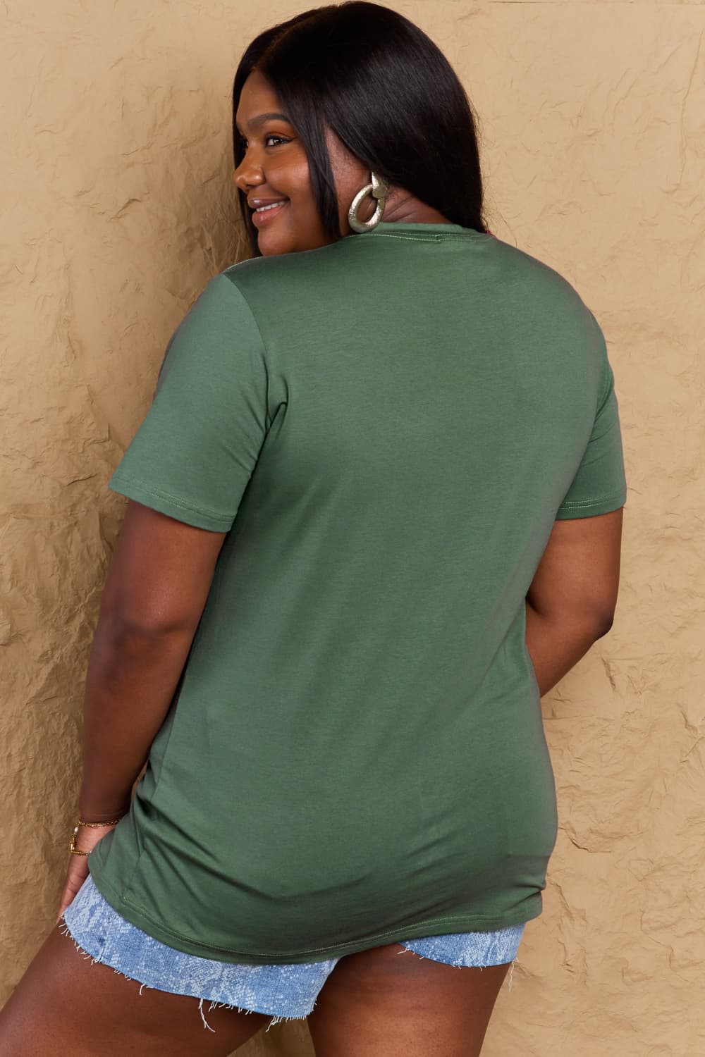 Back view of woman wearing Graphic Cotton T-Shirt, FIND INNER PEACE print, full size fit, casual style, green color.