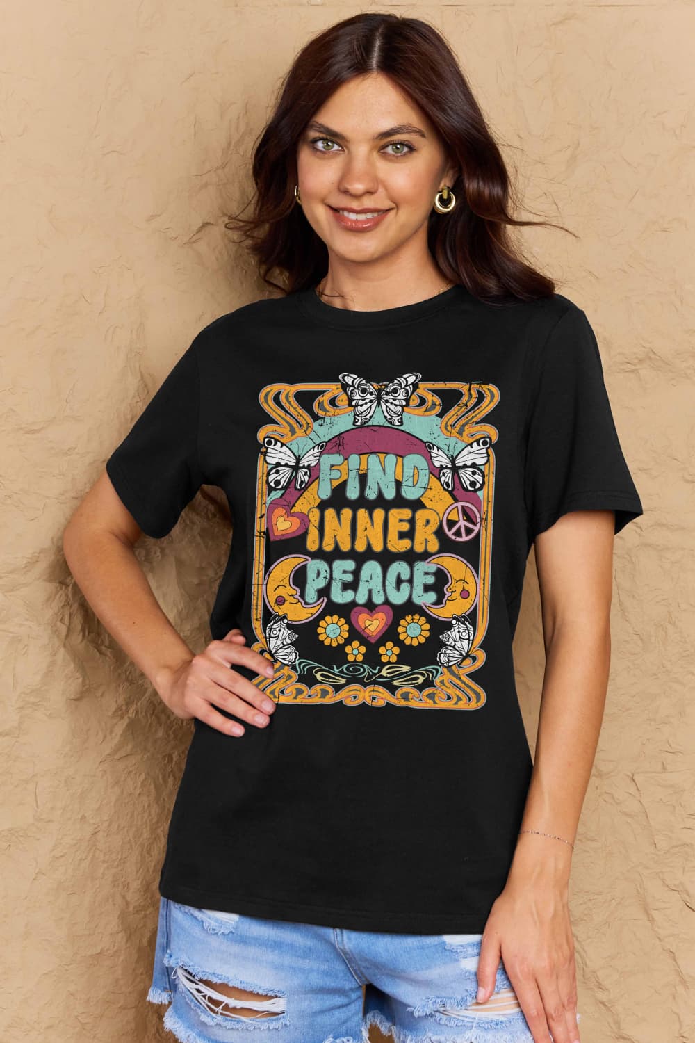 Woman wearing Graphic Cotton T-Shirt with 'FIND INNER PEACE' print, casual style.