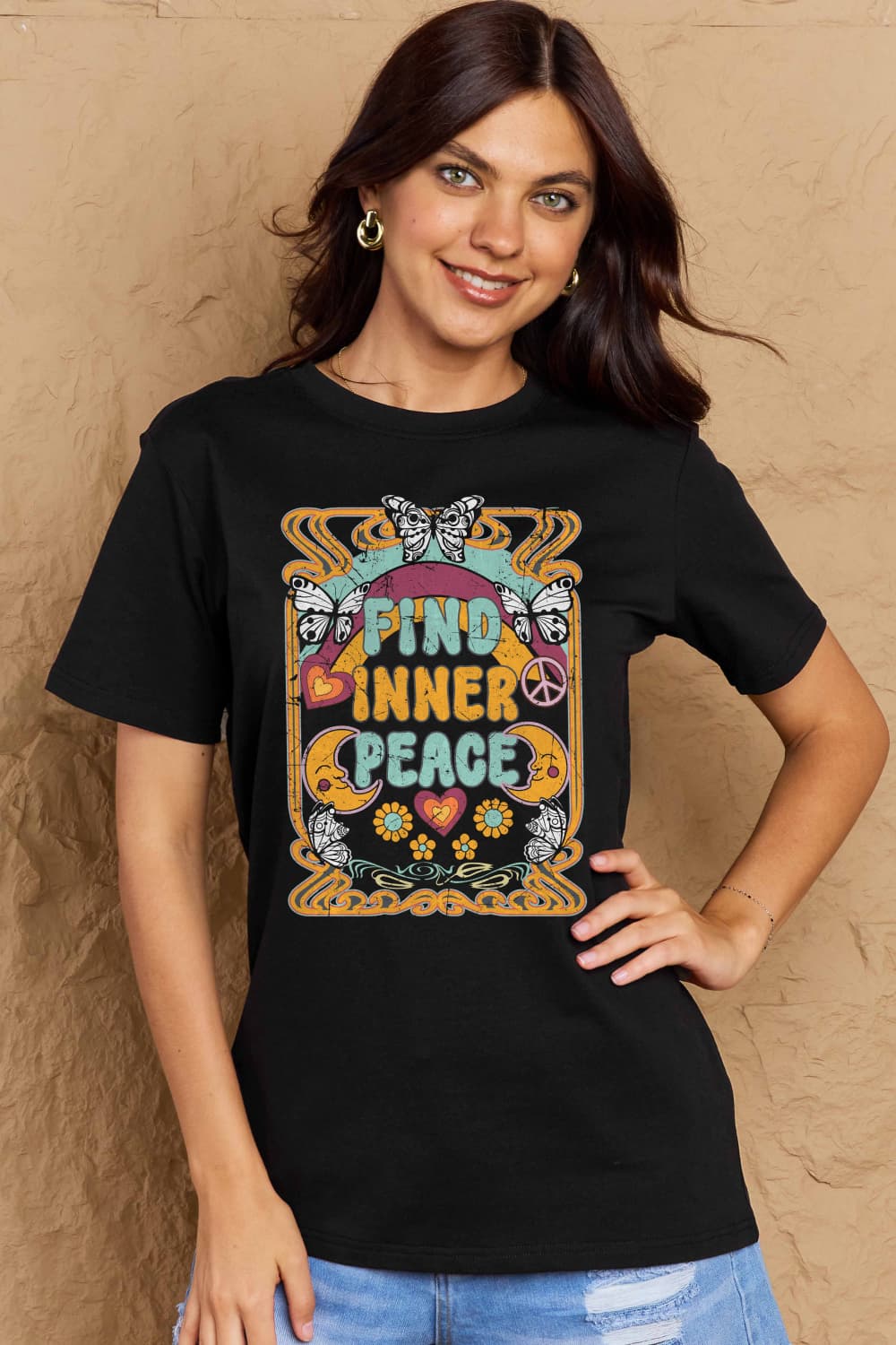 Model wearing black Graphic Cotton T-Shirt with 'FIND INNER PEACE' printed design, casual and stylish look.
