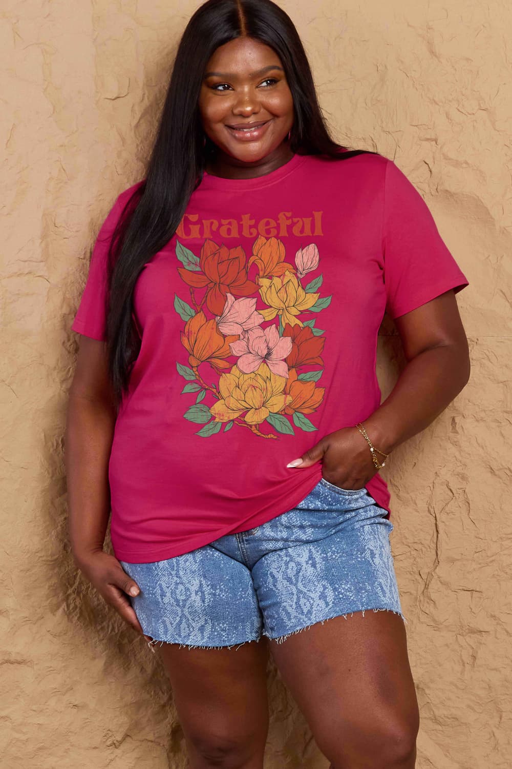 Woman wearing Graphic Cotton T-Shirt with GRATEFUL flower print, showcasing casual style and positive vibes, full-size fit