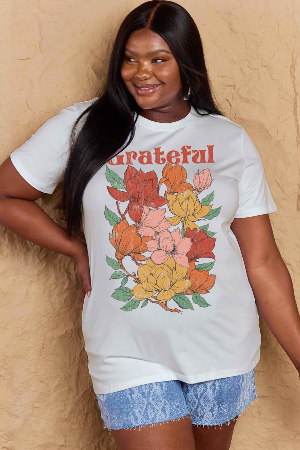 Woman wearing a Graphic Cotton T-Shirt with 'GRATEFUL' flower print for a casual look