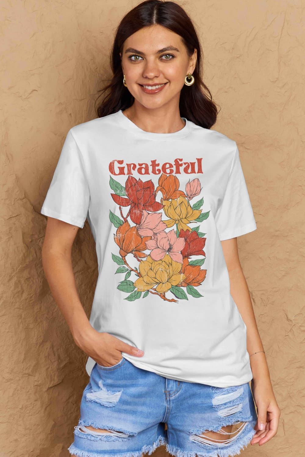 Woman wearing Graphic Cotton T-Shirt with GRATEFUL flower print in full size, casual style, enhancing mood with positive energy.