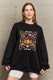Woman wearing Graphic Dropped Shoulder Sweatshirt with colorful design, casual and stylish for everyday wear, perfect layering piece.