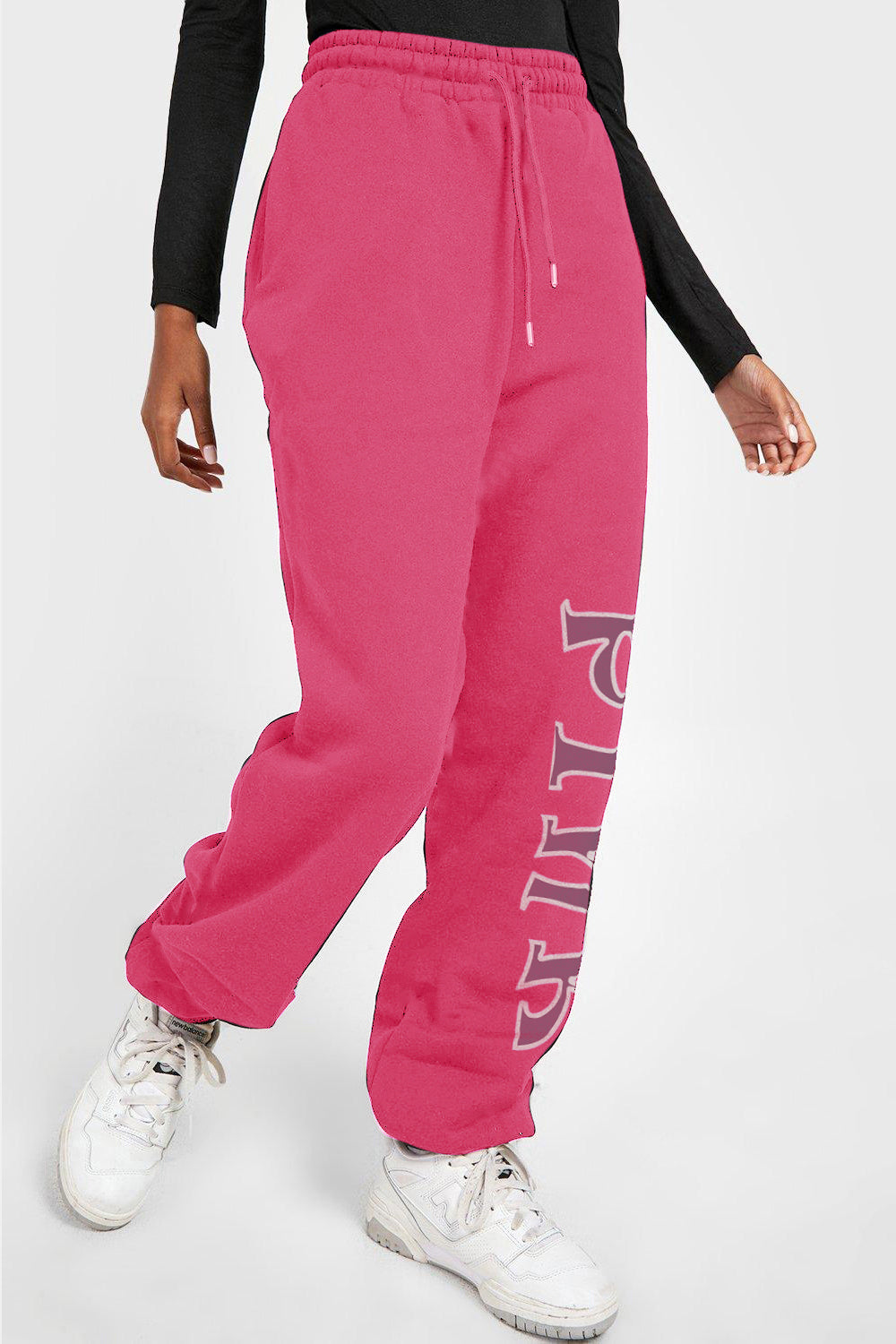 Person wearing Graphic Sweatpants with PINK print, featuring drawstring, perfect for comfort and style.
