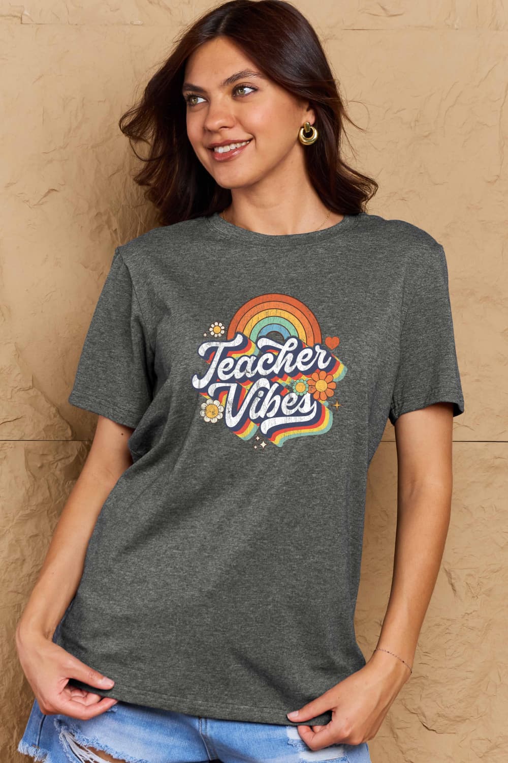 Woman wearing Graphic Cotton T-Shirt with 'TEACHER VIBES' print, celebrating creativity and positivity in casual style.