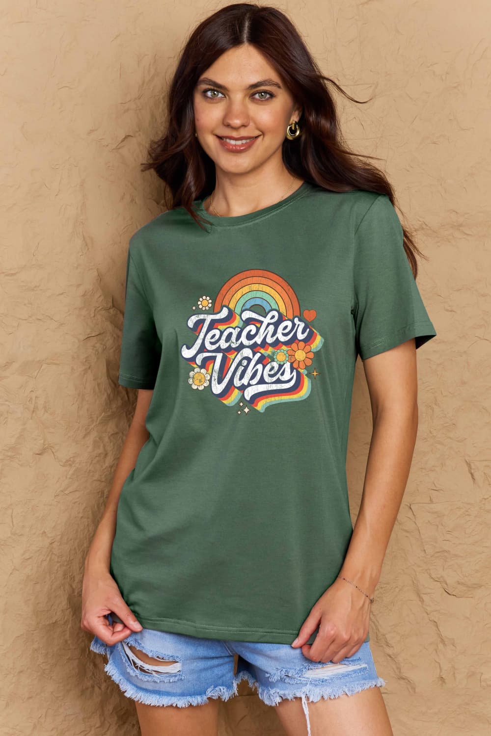 Woman wearing Graphic Cotton T-Shirt with TEACHER VIBES print, ideal for teachers and casual style.