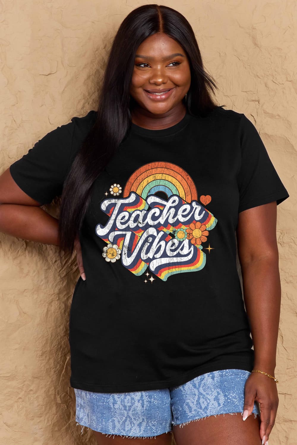 Woman wearing a Graphic Cotton T-Shirt with 'TEACHER VIBES' print, showcasing casual style and personality