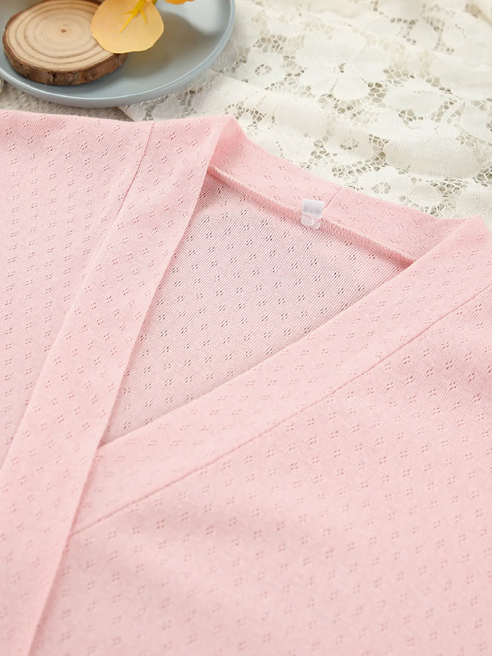 Close-up of pink Tie Waist Lounge Nightgown with kimono sleeves showing fabric texture on a lace background.