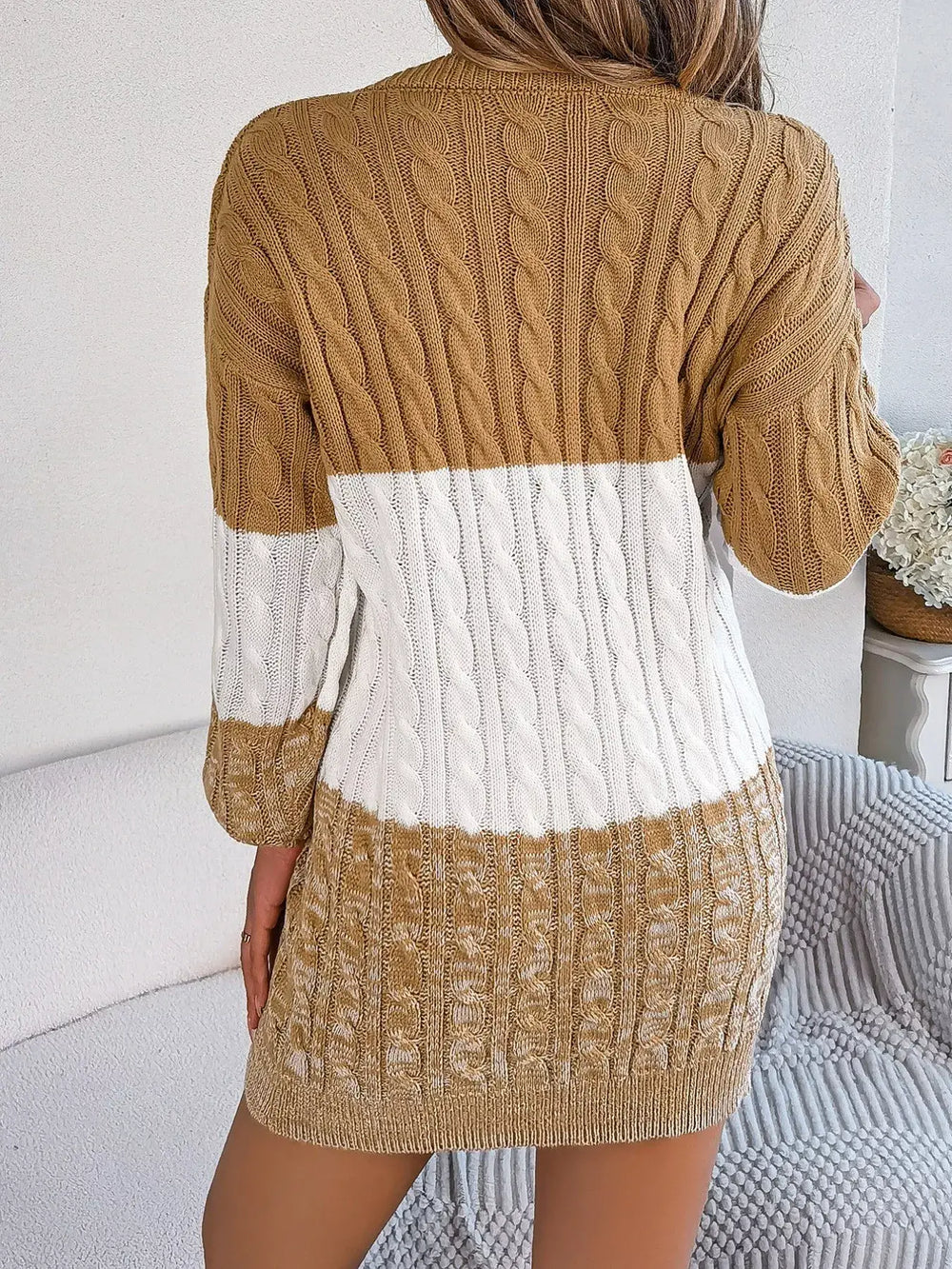 Back view of color block cable knit sweater dress with textured pattern, showcasing brown and white design, ideal for fall fashion.