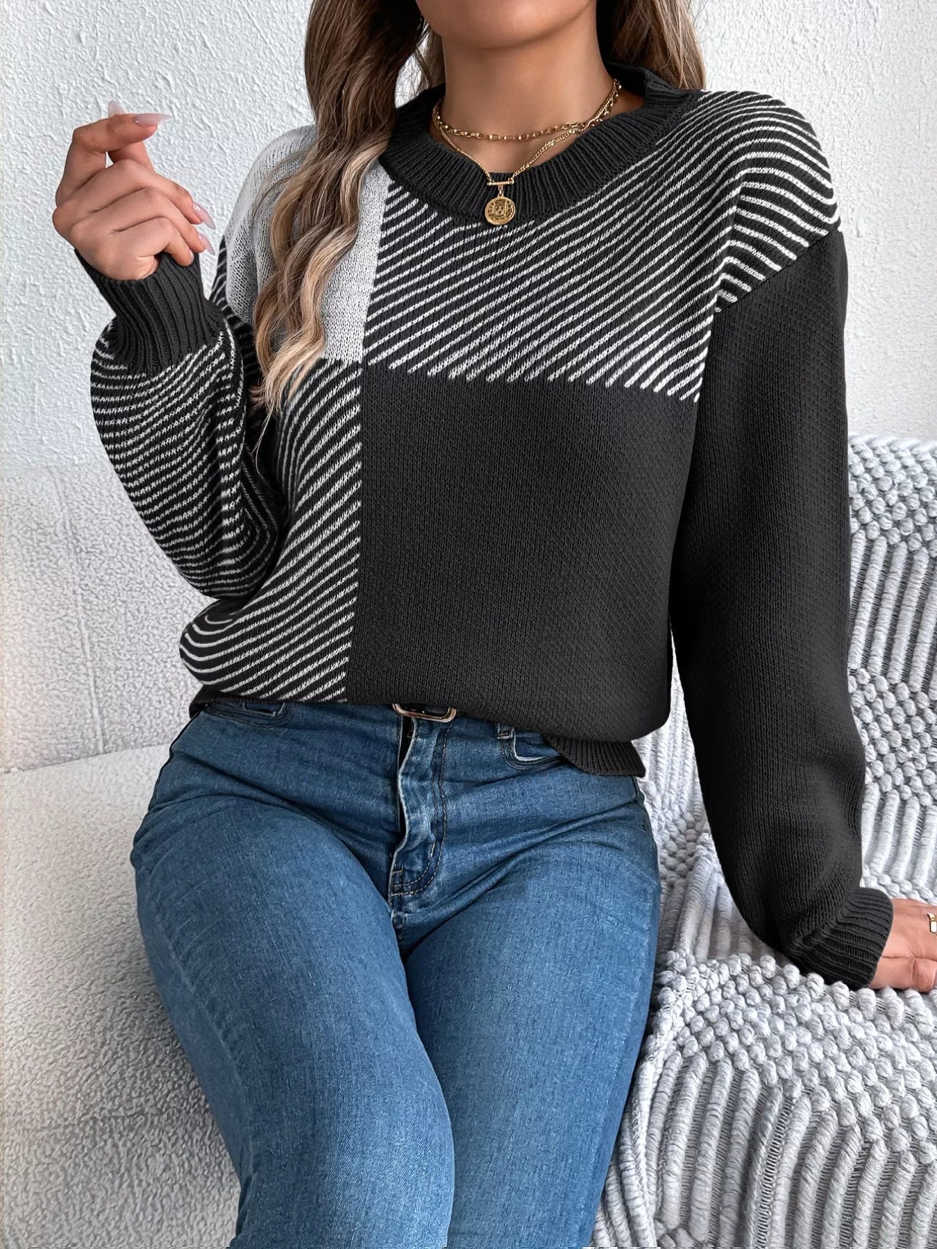 Woman wearing a Color Block Striped Sweater with round neck, featuring bold color block pattern, perfect for cozy casual style.