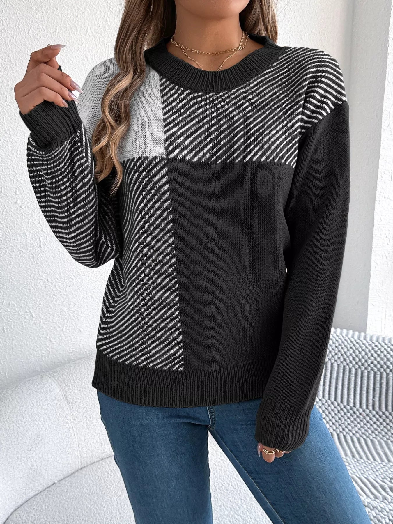 Woman wearing Color Block Striped Sweater with round neck and bold patterns, showcasing casual sophistication and cozy style.